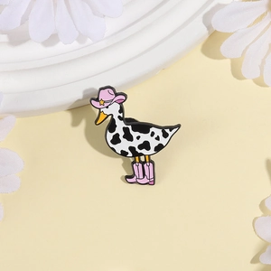 Cute cartoon cow-pattern duck enamel pin wearing a pink cowboy hat and boots