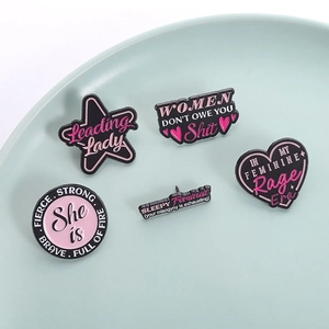 Five-piece set of pink and black enamel pins with star and heart shapes in a display tray