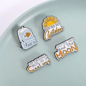 Creative enamel pins set featuring backpack fish design and golden slogan quotes