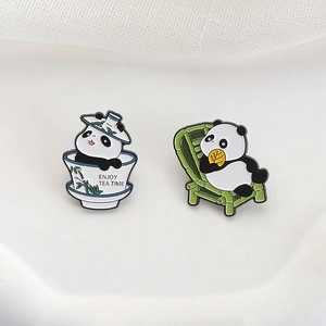 Cute panda enamel pins featuring a panda in a tea cup and another on a lounge chair