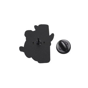 Detail of metal panda enamel pin back showing needle and black rubber clutch backing