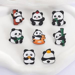 Detailed set of 8 panda enamel pins with bamboo and rocking horse on a white tray