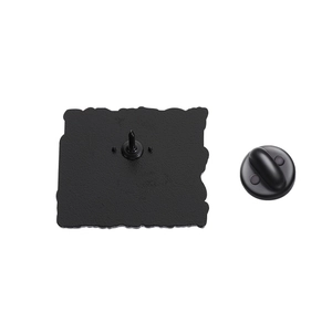 Detailed view of black enamel pin back with metal needle and rubber clutch backing