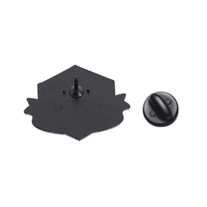 Macro detail showing the black matte metal back of the shield badge with a rubber pin clutch