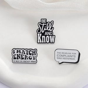 Three-piece minimalist black and white enamel pins set with witty English text