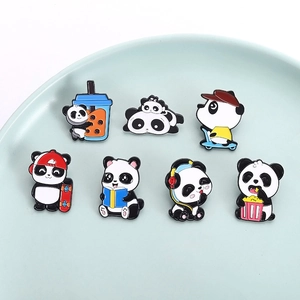 Set of seven cute cartoon panda enamel pins in various poses on a ceramic plate