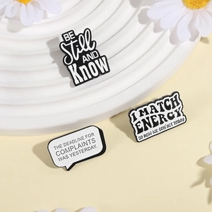 Three-piece set of creative enamel slogan pins with black and white minimalist typography