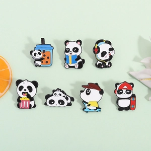 Set of 7 cute cartoon panda enamel pins featuring various creative poses on green background