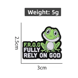 Detail view of a green frog enamel pin showing its 2.5cm by 3cm size and 5g weight