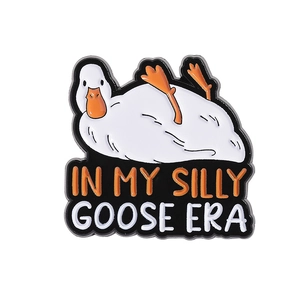 Detailed view of enamel pin featuring a cartoon goose with 'IN MY SILLY GOOSE ERA' text