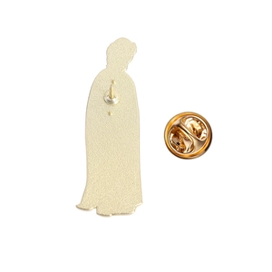 Close-up of golden enamel pin back showing the butterfly clutch and metal silhouette