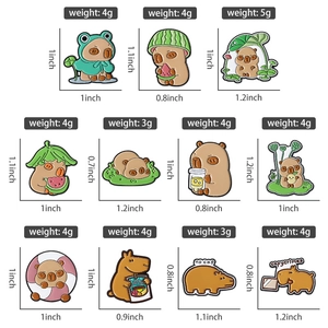 Detail showing various capybara enamel pins with size and weight measurements in inches