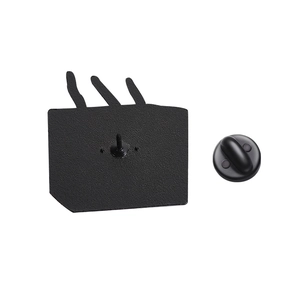 Detail of matte black metal badge back with butterfly pin and rubber clutch attachment