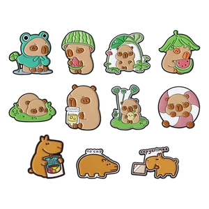 Cute set of 11 Capybara enamel pins with watermelon, lotus leaf, and frog outfits