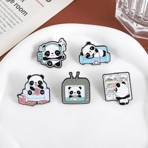Cute panda enamel pin set with various cartoon activities on a white ceramic plate