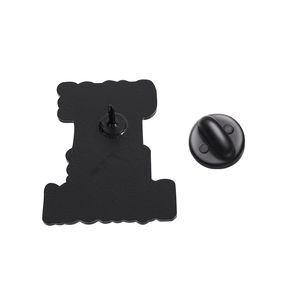 Detail view of the black metal brooch back with a secure rubber butterfly clasp and pin