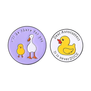 Set of two silly goose enamel pins featuring a purple and white round cartoon duck design