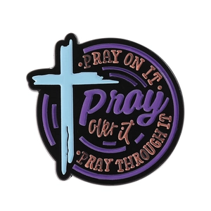 Religious round enamel pin with cross design and Pray On It inspirational text