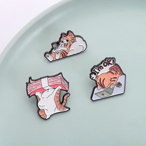 Three cute orange cartoon cat enamel pins showing daily life and work office scenes
