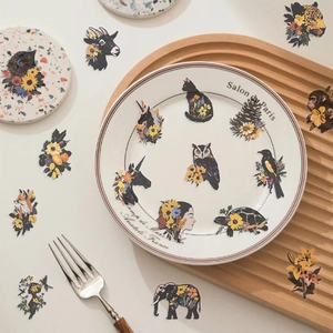 Artistic vintage animal and flower PET stickers scattered on a warm decorative setting