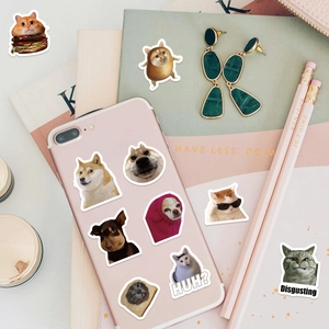 Close-up of cat and dog meme stickers on a pink iPhone and notebook cover