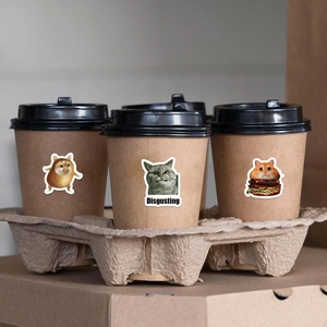Funny cat stickers applied on a coffee cup showing creative food themes and expressions
