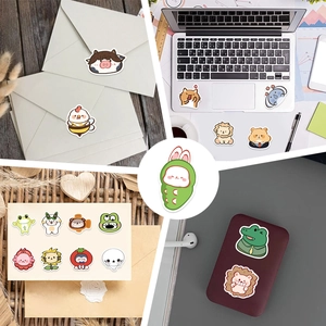 Detailed view of colorful cartoon animal stickers applied to laptops and envelopes