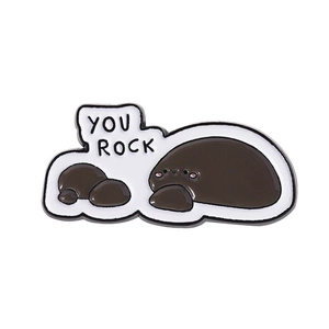 Cute enamel rock pin featuring 'YOU ROCK' text on a minimalist white background