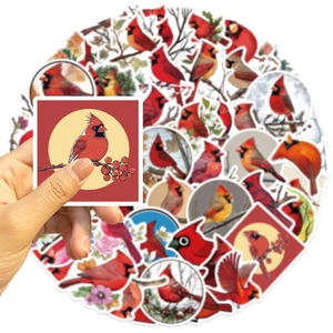 Close-up of red cardinal bird stickers with floral motifs for DIY guitar decoration
