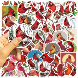 Close-up of hand holding a waterproof red cardinal bird sticker for DIY decoration