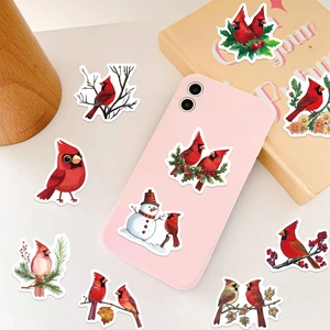 Red cardinal bird stickers applied to a pink smartphone and notebook for DIY decoration