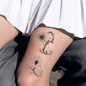 Détail d'un tatouage temporaire pissenlit noir imperméable sur la jambe d'un modèle