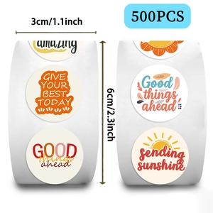 Detail showing 1.1 inch round sun phrase stickers with motivational quotes on a roll