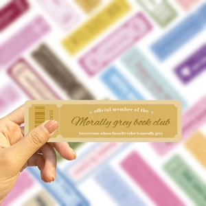 Close-up of Morally Grey Book Club vintage ticket bookmark held in hand with soft focus