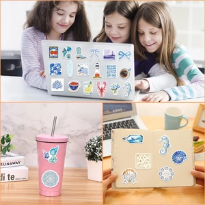 Waterproof blue aesthetic stickers showing marine life and lifestyle icons on a laptop