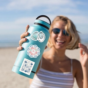 Blue ocean aesthetic waterproof stickers featuring seashell patterns on a water bottle