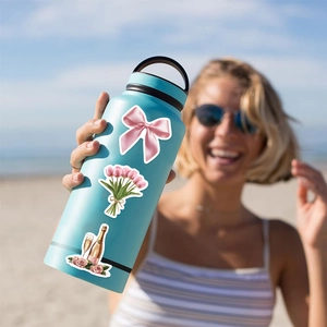 Waterproof aesthetic pink stickers featuring bow and tulip designs on a blue water bottle