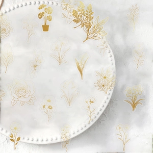 Golden floral and butterfly stickers on white ceramic plate for DIY decoration