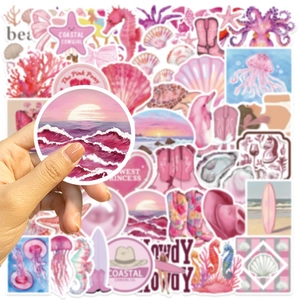 Close-up of pink Coastal Cowgirl stickers featuring sea life and aesthetic western boots