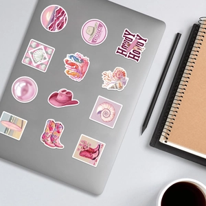 100pcs coastal cowgirl stickers with pink beach motifs on a silver laptop lid