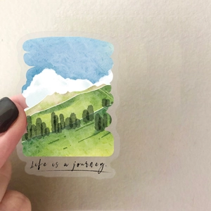 Close-up of waterproof transparent landscape sticker featuring hand-drawn green hills