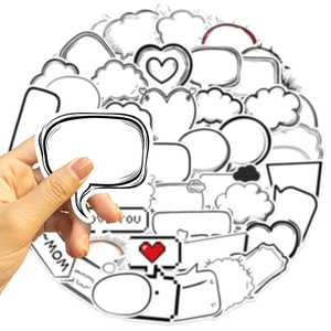 Close-up of hand holding black and white bubble graffiti stickers for DIY decoration