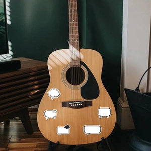 DIY black and white bubble stickers applied on an acoustic guitar for creative decoration
