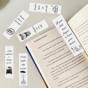 Minimalist black and white paper bookmarks with English quotes next to a classic book