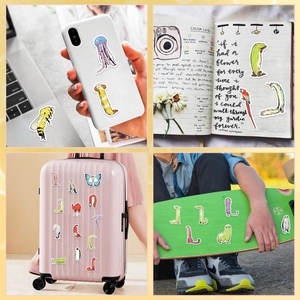 Close-up of waterproof cartoon animal stickers applied to a phone case and laptop cover