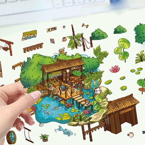 Détail d'une main décollant un autocollant de cabane champignon 3D pour scrapbooking DIY