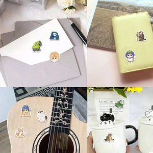 Detail showing cartoon cat stickers applied on notebooks, envelopes, and mugs