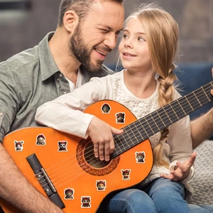 Cute cartoon cat and panda animal stickers decorated on a guitar in a home setting