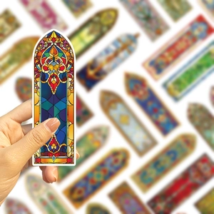 Macro shot of Gothic stained glass bookmark held by hand for vintage journal decoration