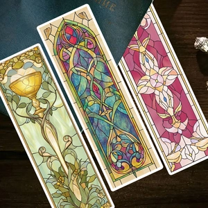 Art Nouveau stained glass bookmarks with floral designs on vintage dark wood background